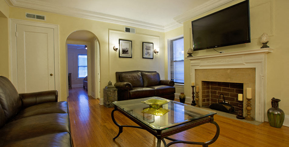 a living room with leather furniture and a fireplace