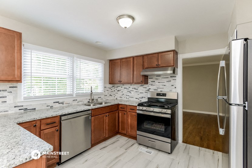 a kitchen with wooden cabinets and stainless steel appliances