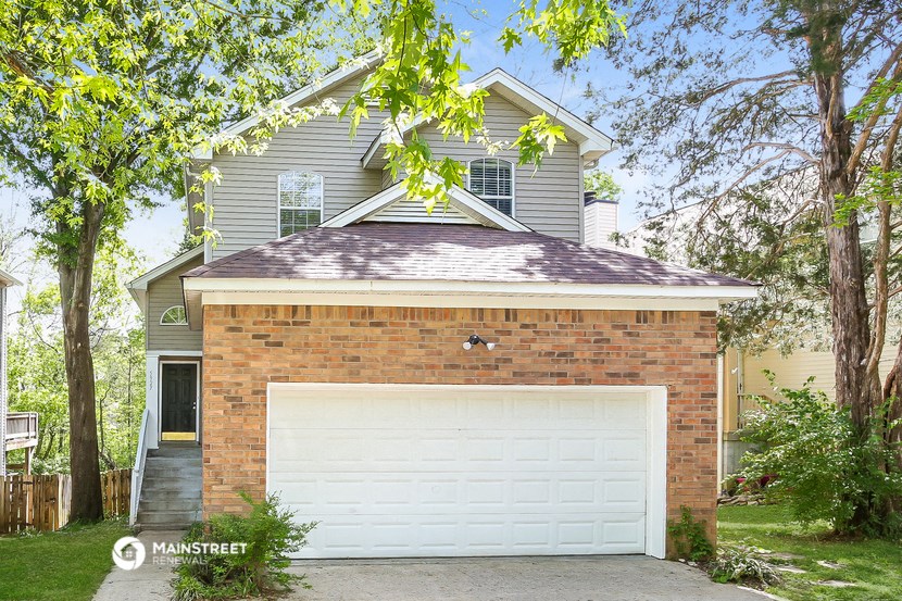 a white garage door in front of a house