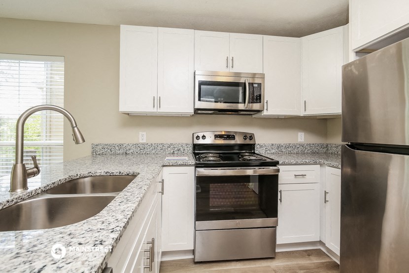 a kitchen with granite counter tops and stainless steel appliances