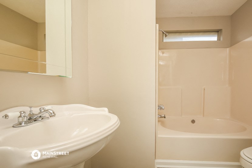 a bathroom with a sink and a shower and a toilet