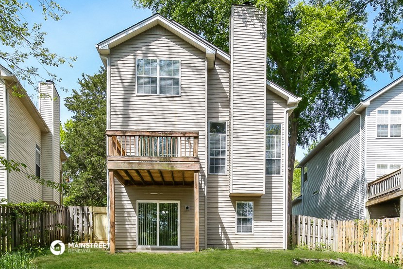 the back of the house has a deck and a balcony