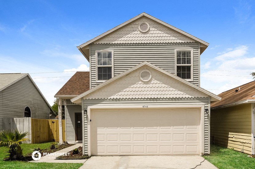 a gray house with a white garage door