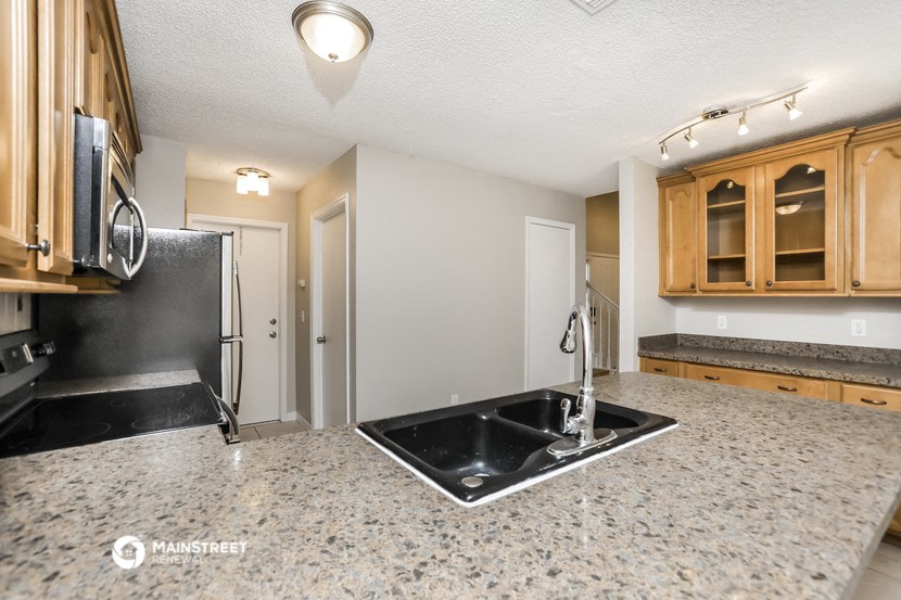 a kitchen with granite counter tops and a sink