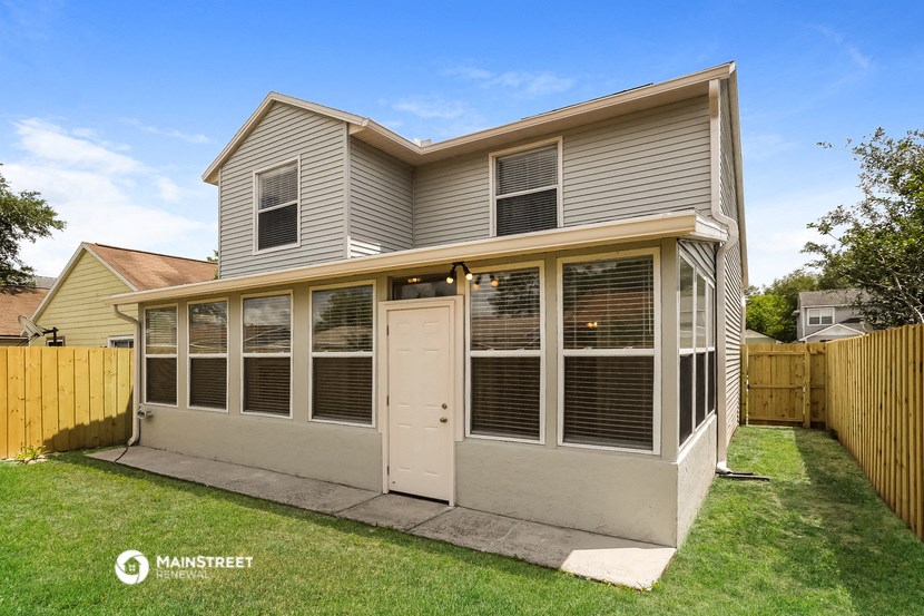 a small with a porch and a white door