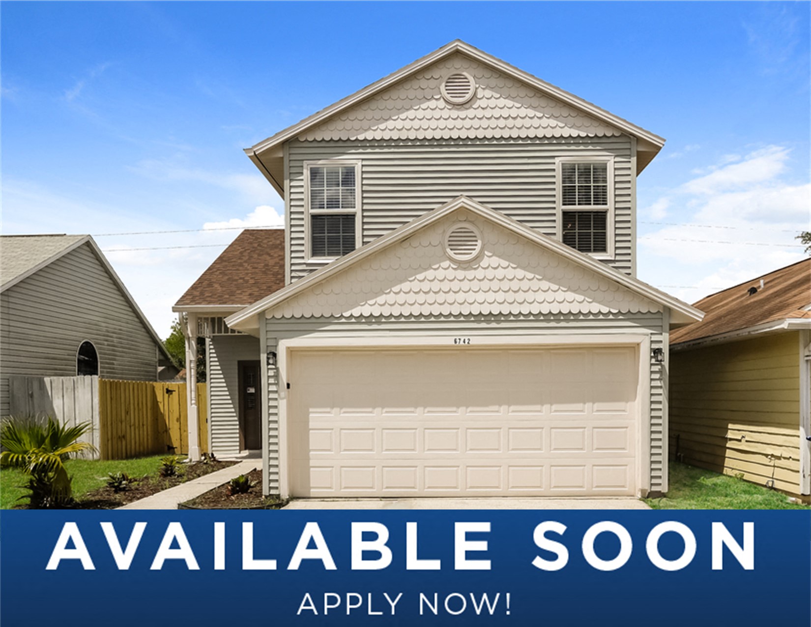 a tan house with a white garage door