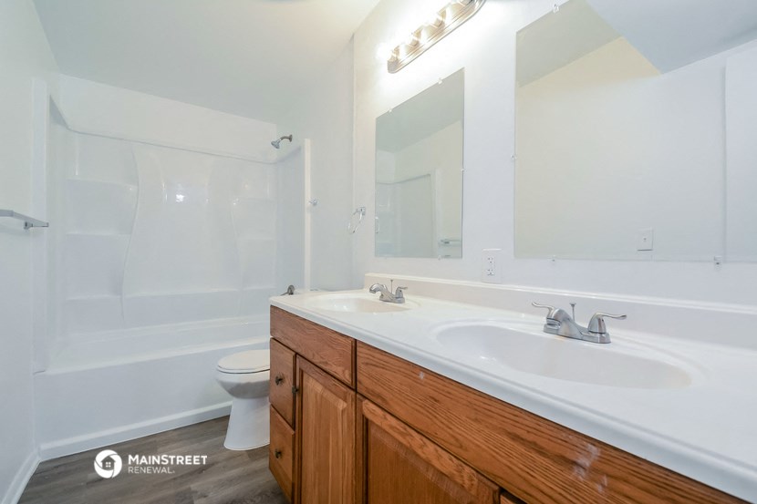 a bathroom with a sink and a toilet and a mirror