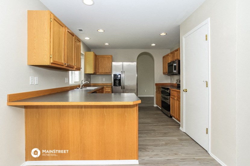 a kitchen with wooden cabinets and a large counter top