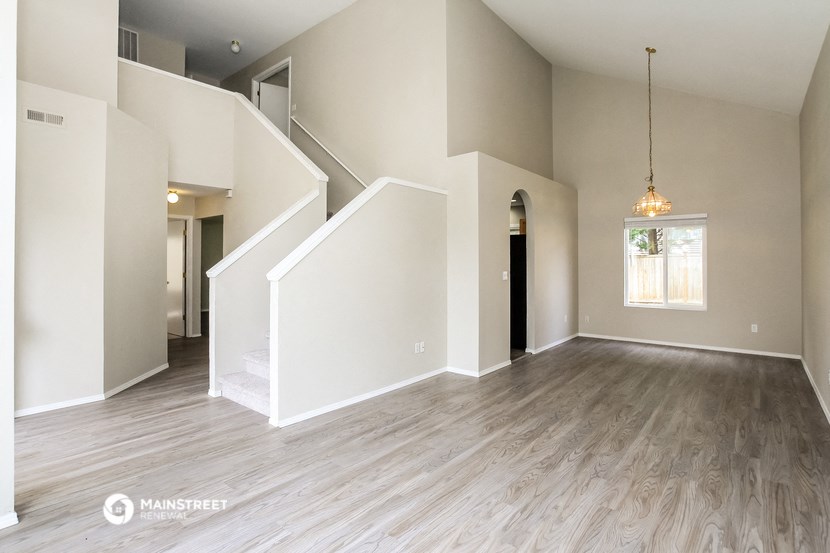 the living room is open to the dining room and kitchen