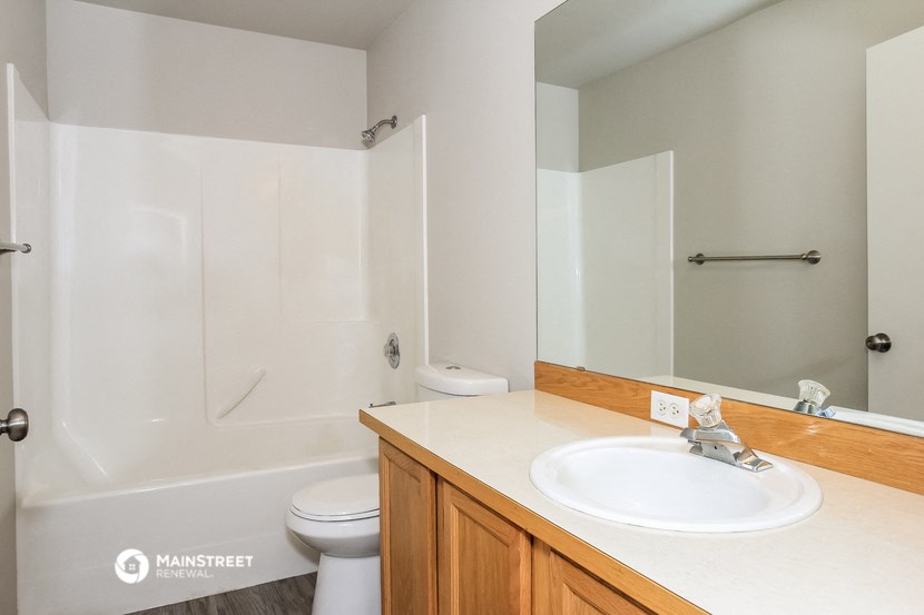 a bathroom with a sink and a shower and a toilet