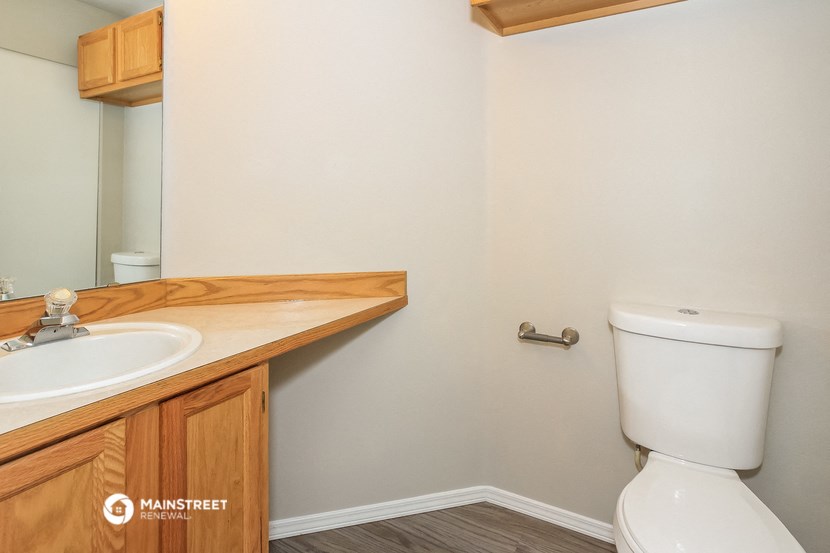 a bathroom with a toilet and a sink and a mirror