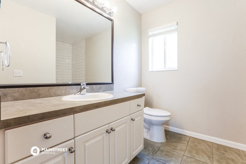 a bathroom with a sink and a toilet and a mirror