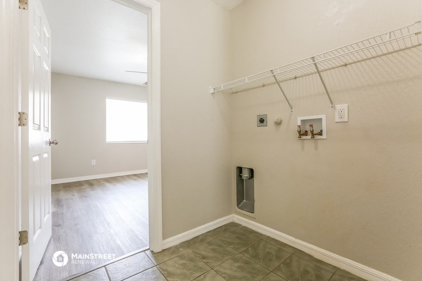 an empty room with a closet and a door to a hallway