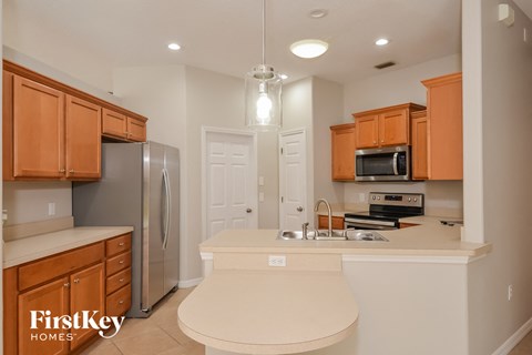 a kitchen with wooden cabinets and a white counter top