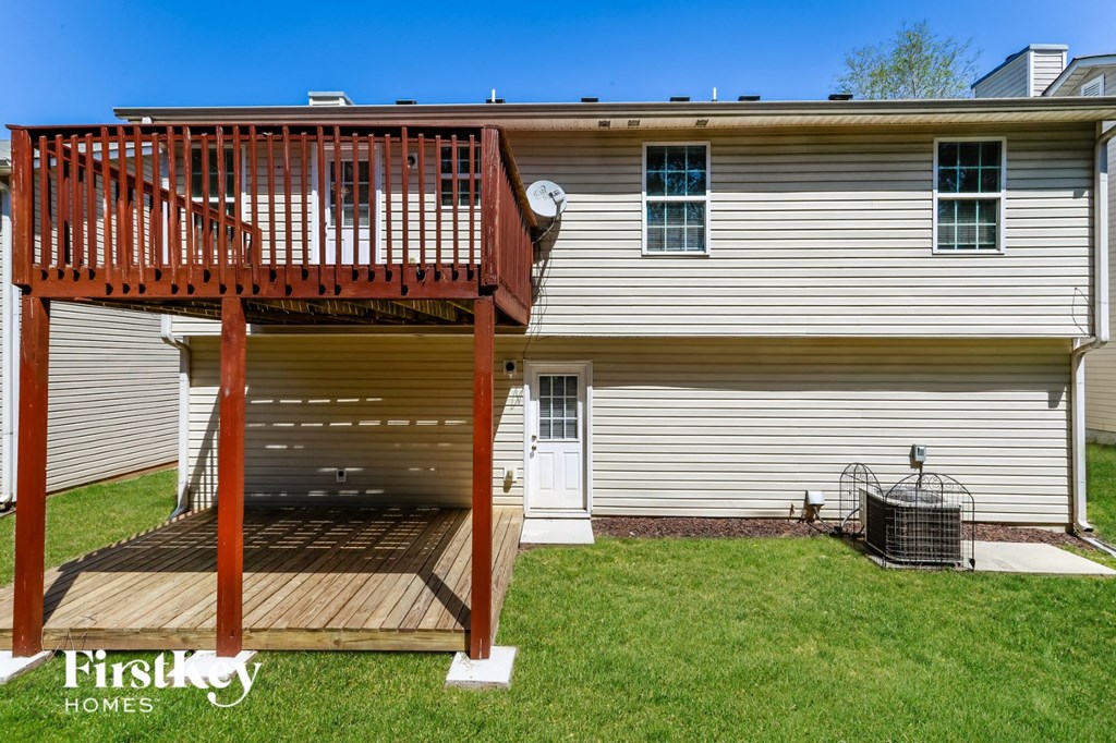 a backyard deck with a composite deck and a privacy fence