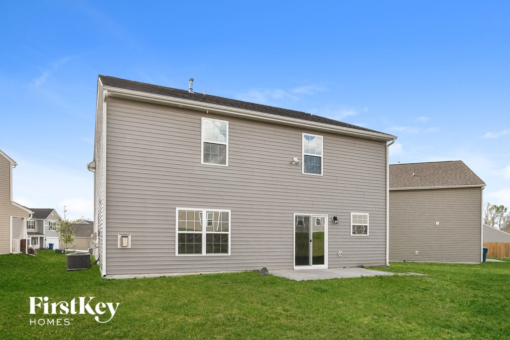 A house with a grey exterior and a white door is shown.