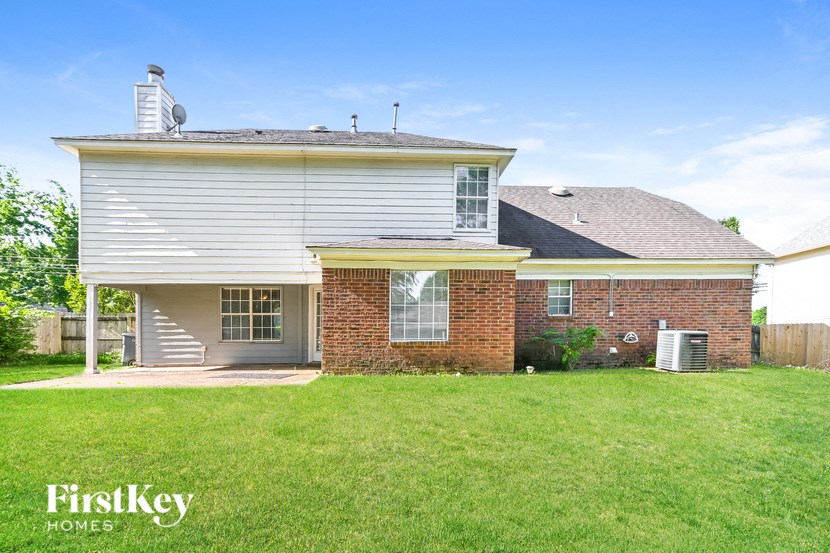 a house with a lawn and a yard in front of it