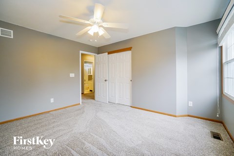 the master bedroom is spacious and has a ceiling fan