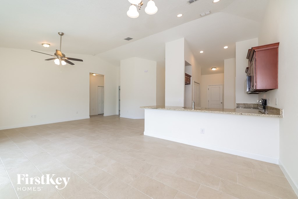 A spacious room with a fan and a countertop.
