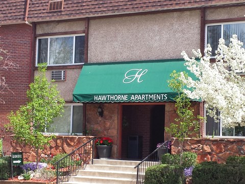 the front of a building with a green awning