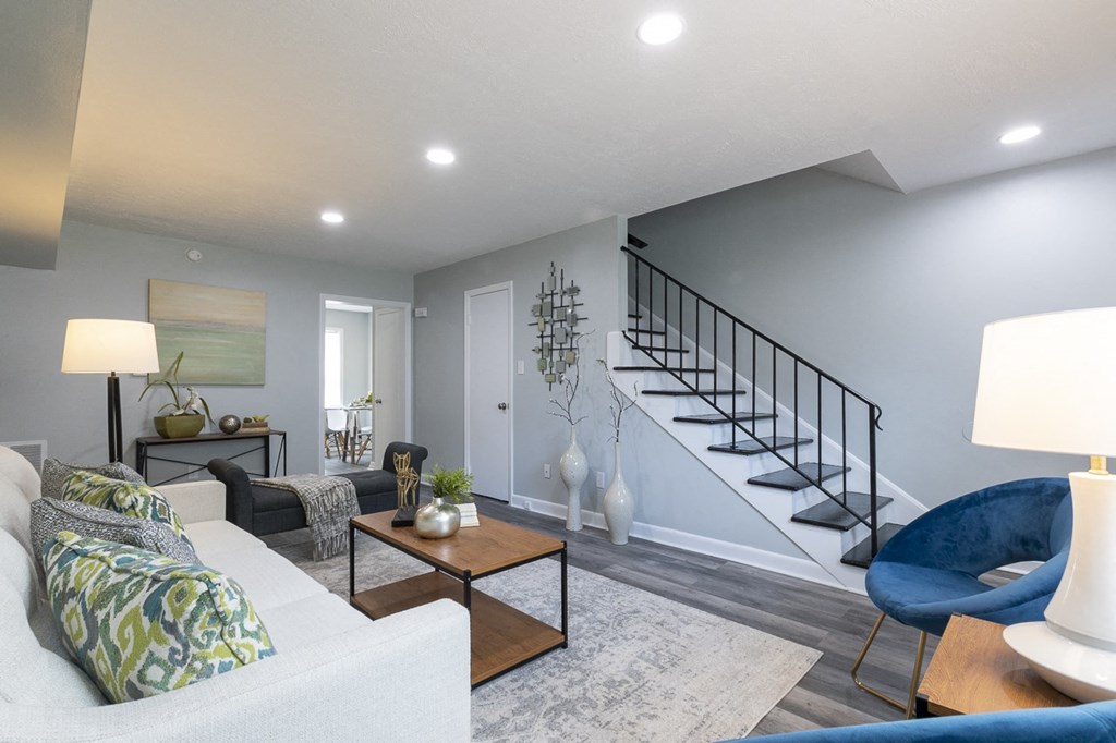 a living room with a couch and a staircase