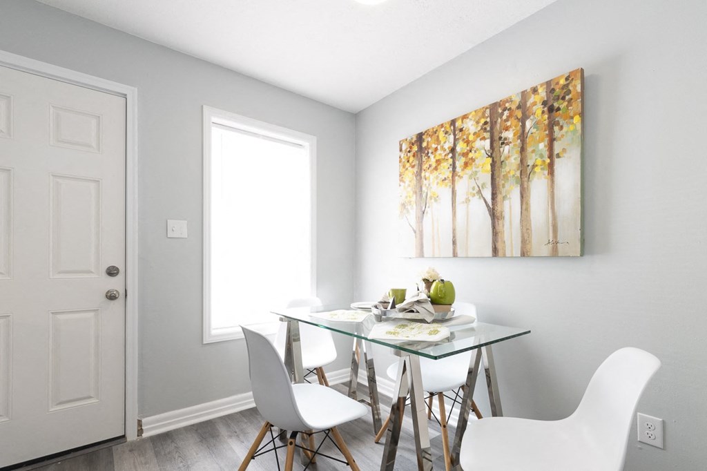an image of a dining room with a table and chairs