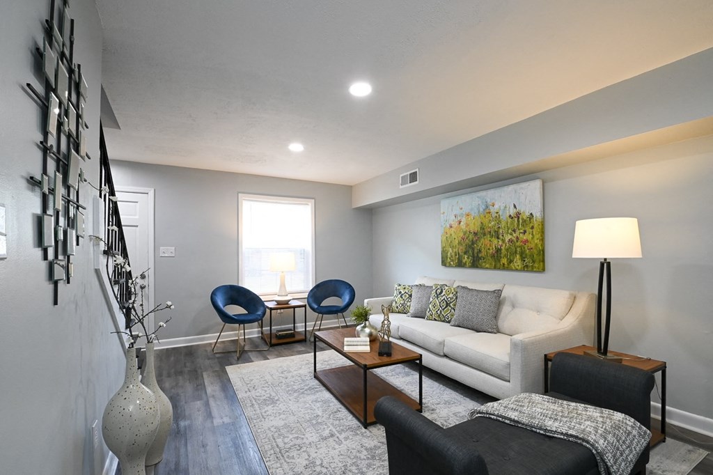 a living room with grey walls and a white couch