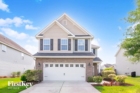 A house with a garage and a driveway is for sale.