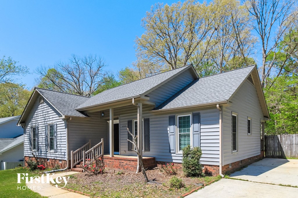 a white house with blue siding and a front porch