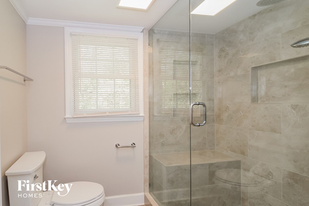 a small bathroom with a shower and a toilet