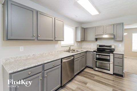 a kitchen with stainless steel appliances and granite counter tops