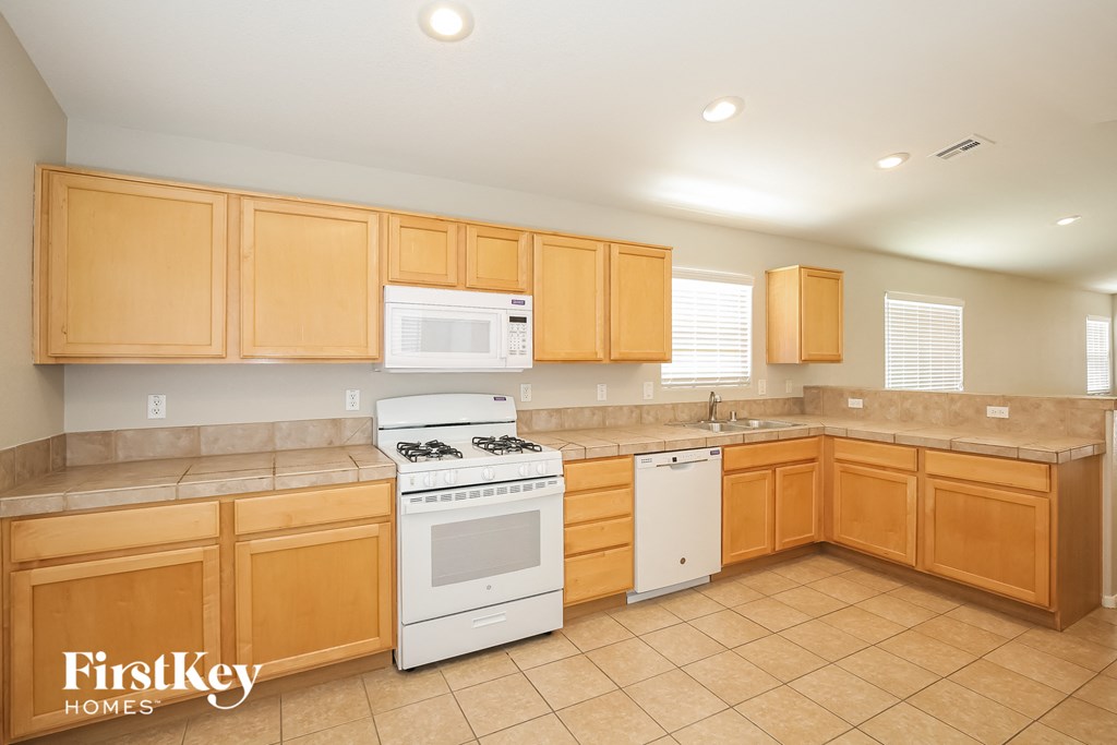 a kitchen with white appliances and wooden cabinets