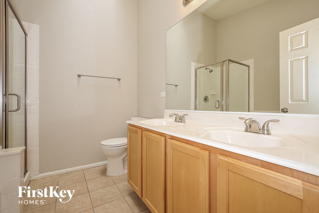 a bathroom with a toilet and a sink and a mirror