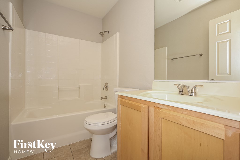a bathroom with a toilet and a sink and a tub