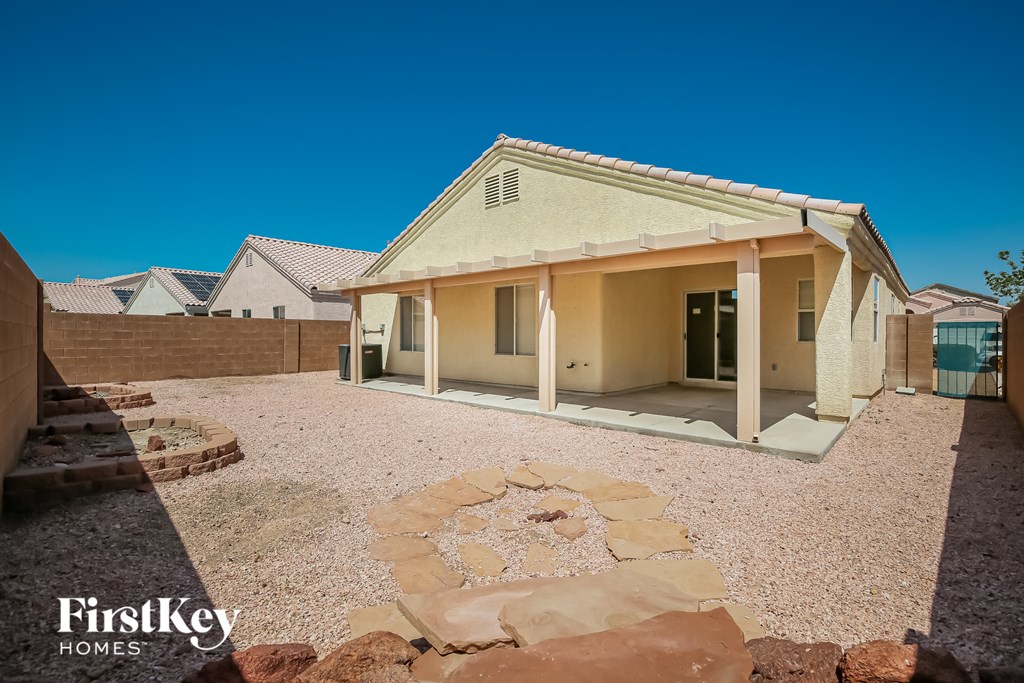 a house with a patio and a stone circle in the ground
