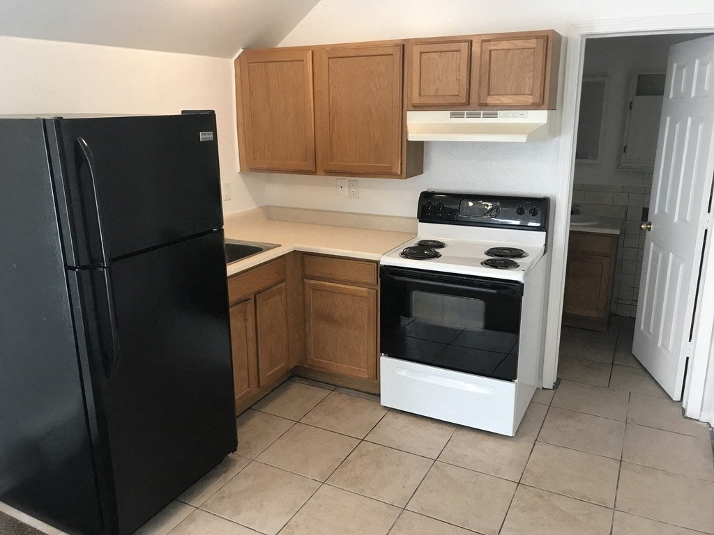 a kitchen with a stove and a refrigerator