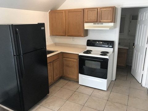 a kitchen with a stove and a refrigerator