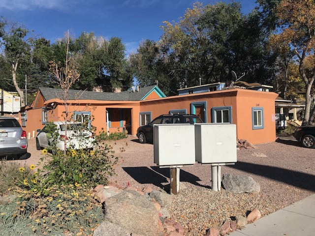 a house with two electrical boxes in front of it