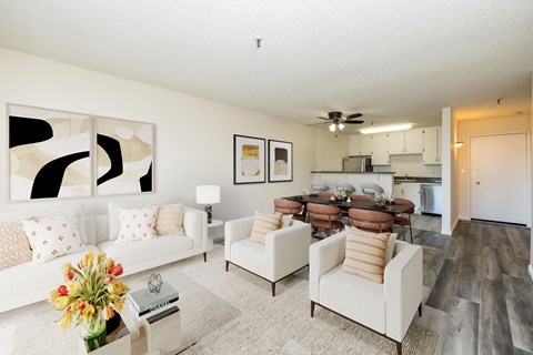 A modern living room with a white couch and a coffee table.