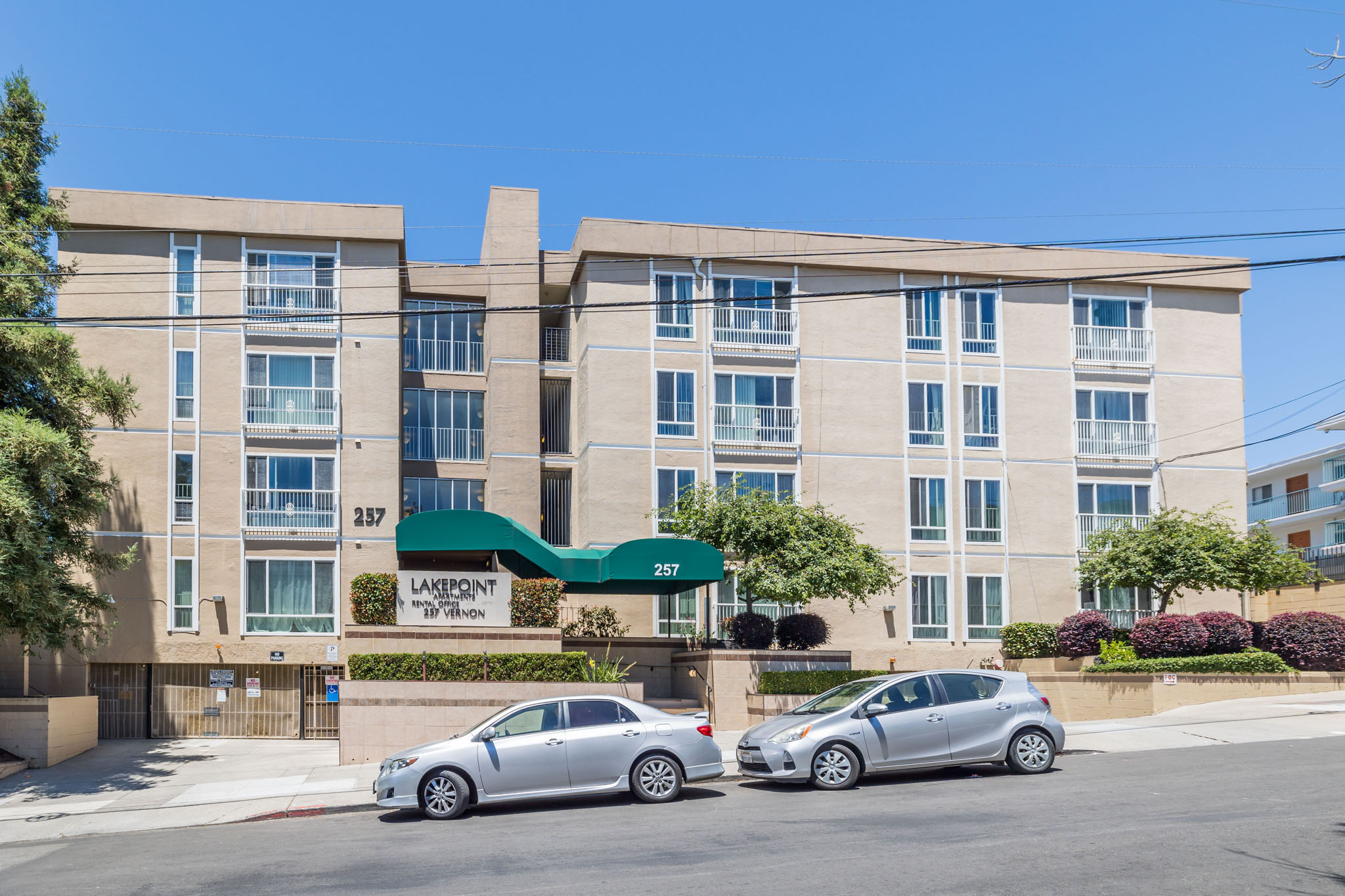 A building with the sign "Lakepoint" is visible with two cars parked in front.