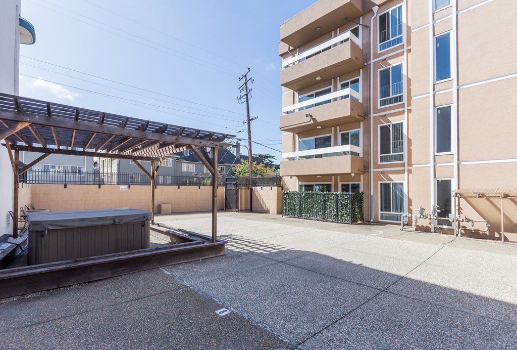 a courtyard with a hot tub in front of a building