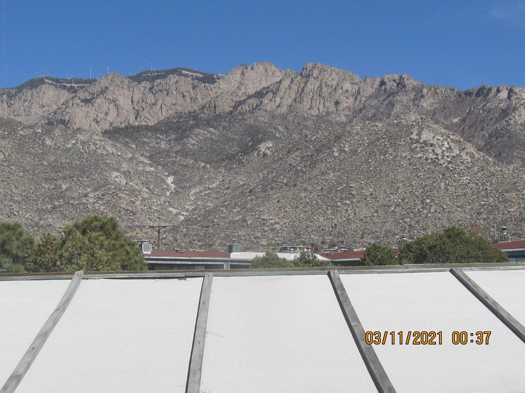 A mountain range with a clear blue sky above it.