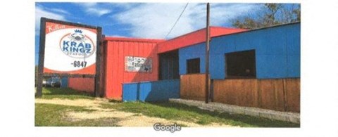 A Krab King restaurant with a red and blue building.
