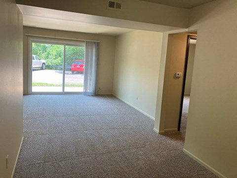 an empty living room with a sliding glass door