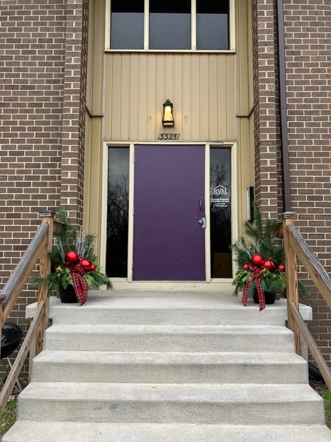 the front door of a church decorated for christmas