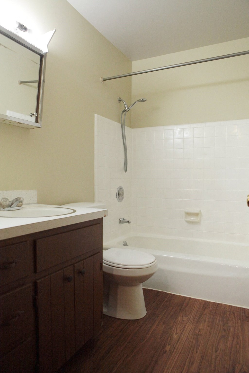 a bathroom with a toilet and a tub and a sink