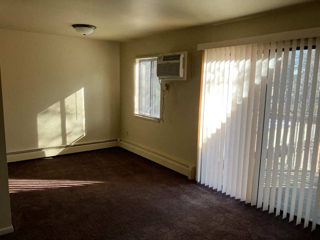 an empty room with white blinds and a window