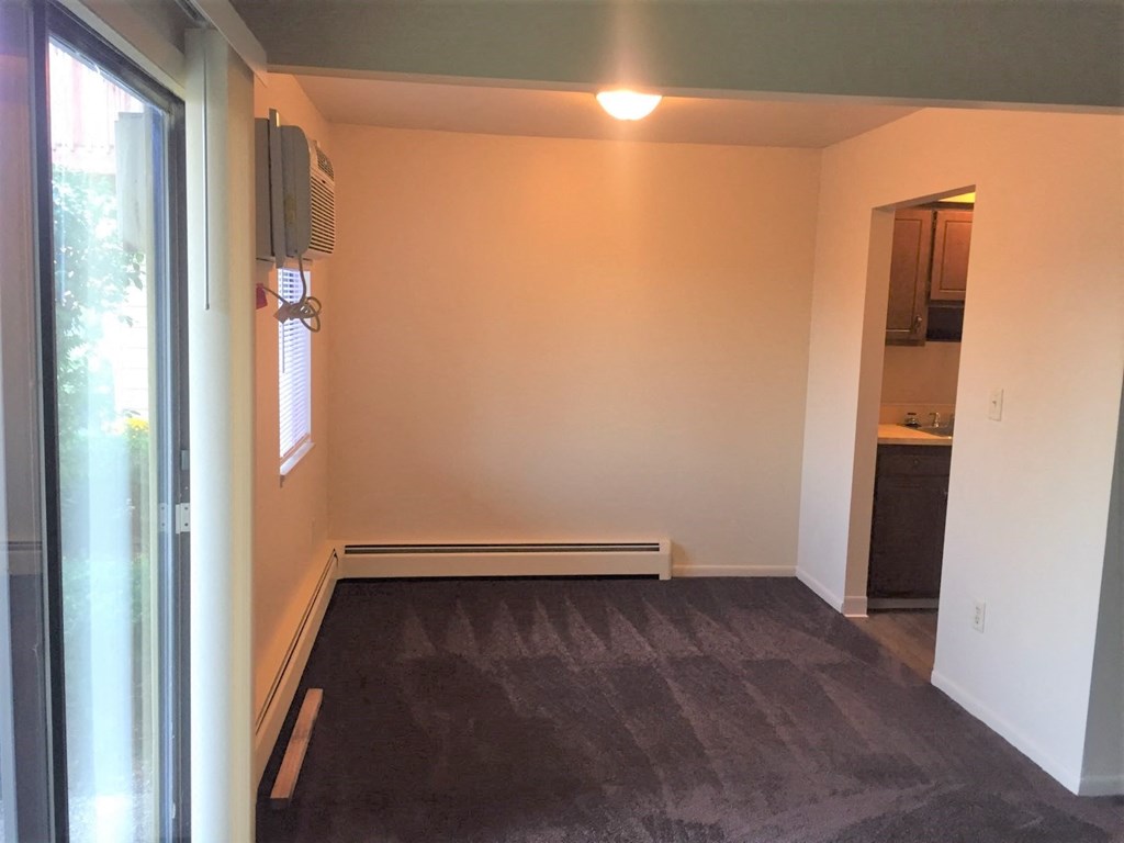 a empty room with a door to a bathroom