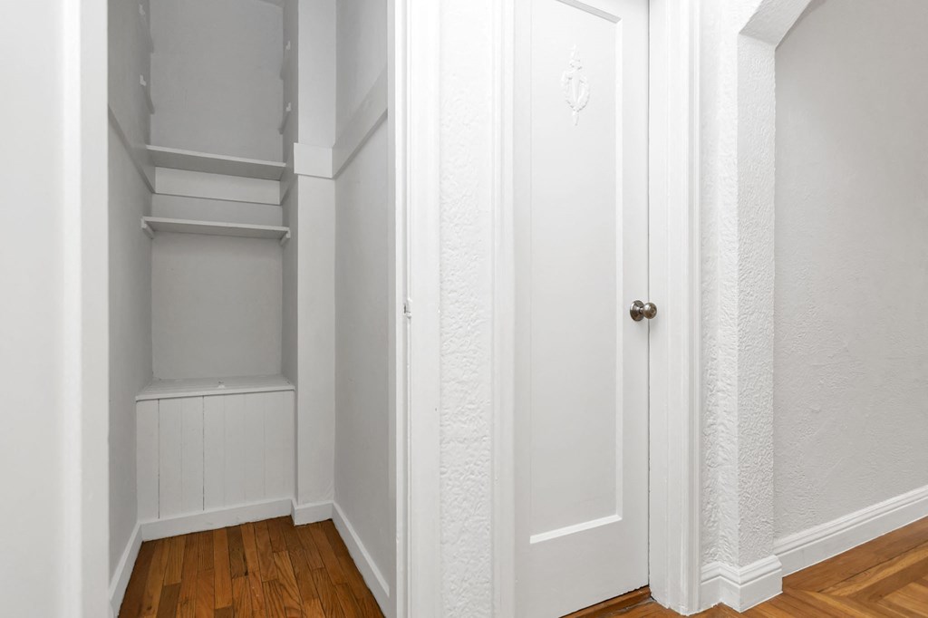 a room with a closet and a wood floor