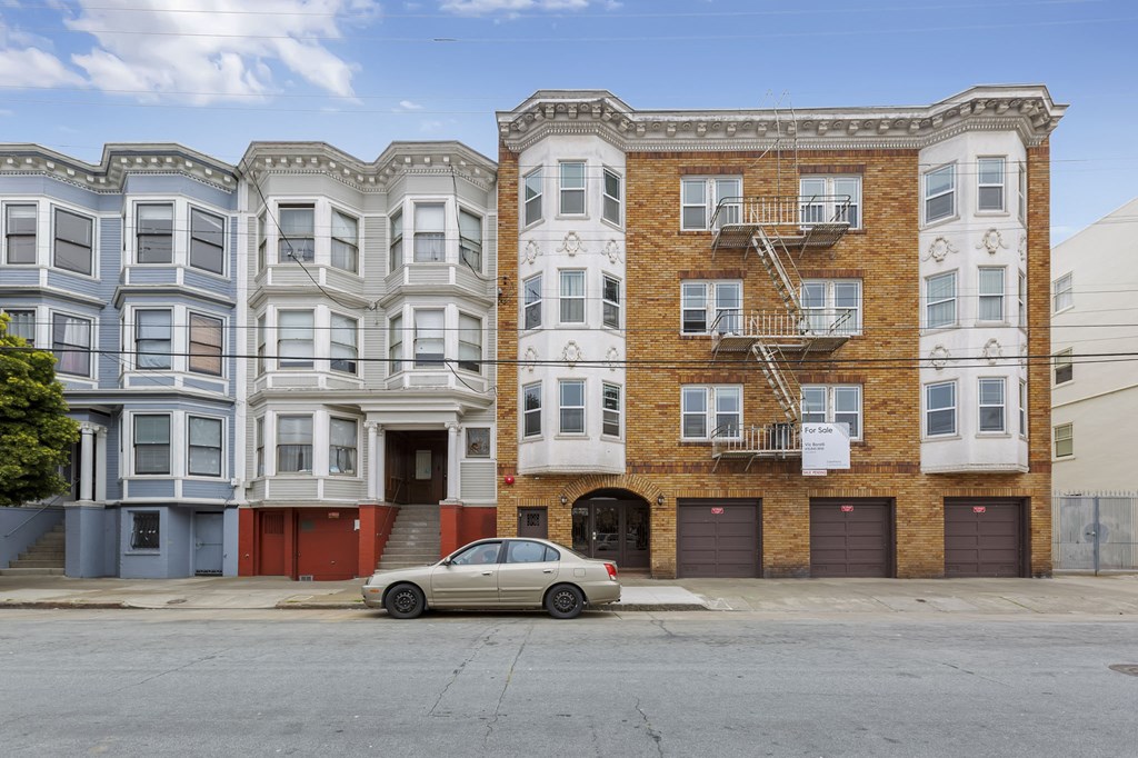 a car parked in front of a building on a street